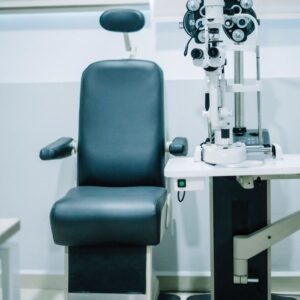 Modern eye exam room featuring an examination chair and advanced ophthalmic equipment.