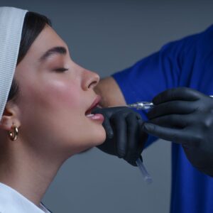 Close-up of a woman receiving a modern cosmetic treatment in a clinical setting.