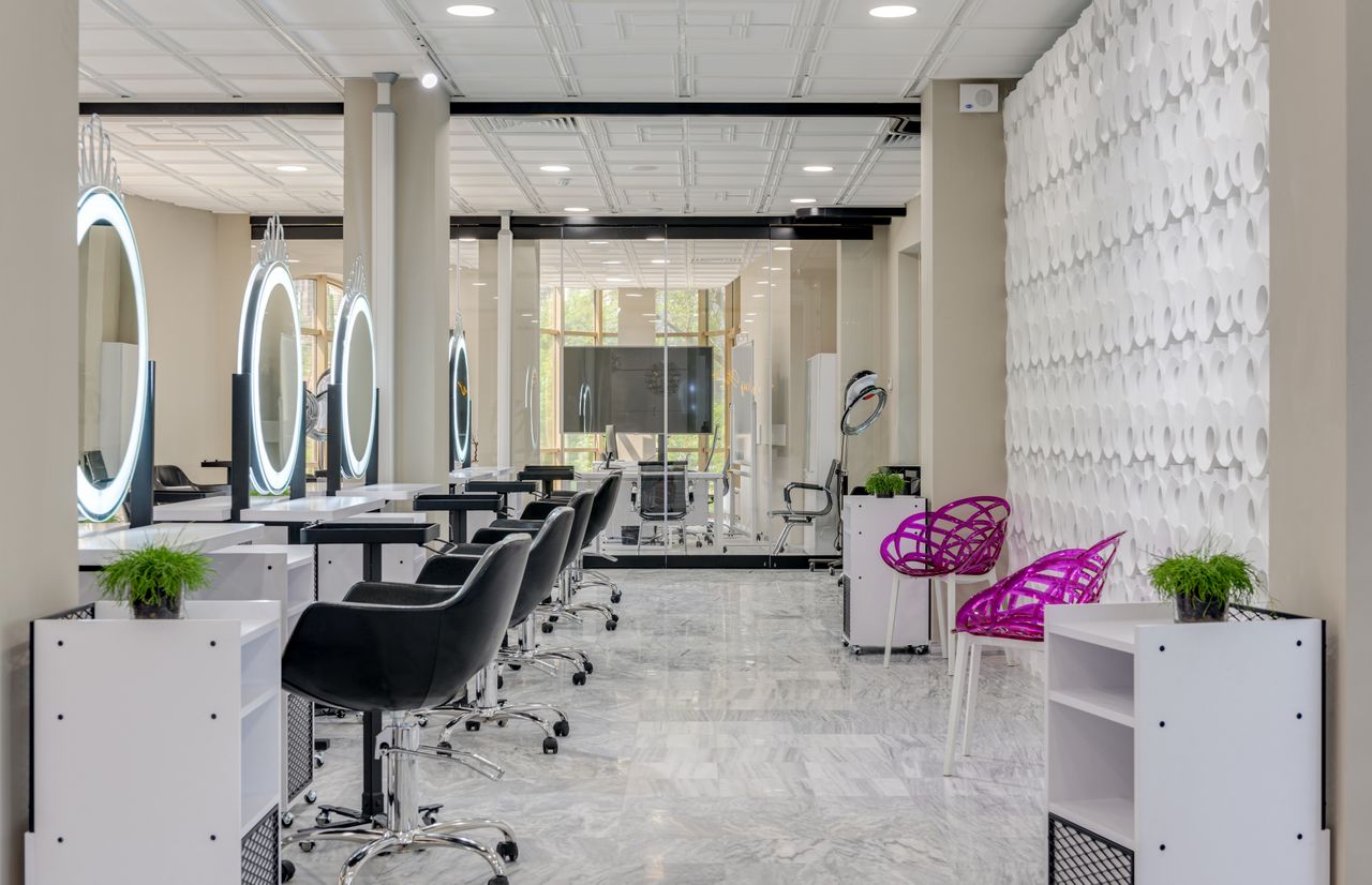 pexels photo 7750108 7750108 Contemporary salon interior featuring sleek chairs and illuminated vanity mirrors.